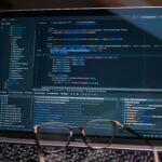 Laptop screen showing debugging software with code, perfect for tech and software development themes.