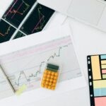 Flat lay of financial charts and tools on office desk, ideal for business and finance concepts.